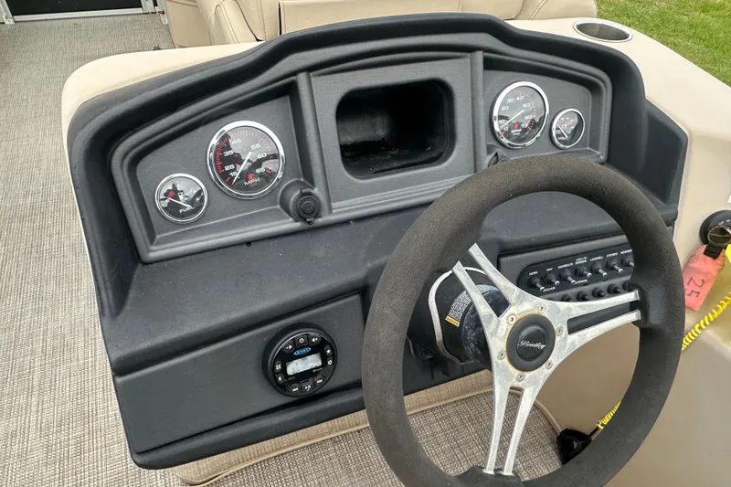 Slide: The Image of Dashboard of a 2021 Bentley Pontoons 240 CRUISE with steering wheel and gauges. - 14