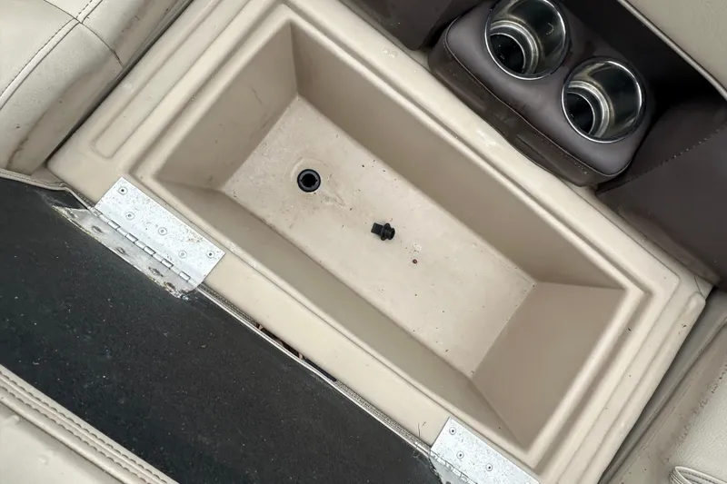 Slide: The Image of 2021 Bentley Pontoons 240 CRUISE storage compartment with cup holders and beige interior. - 17