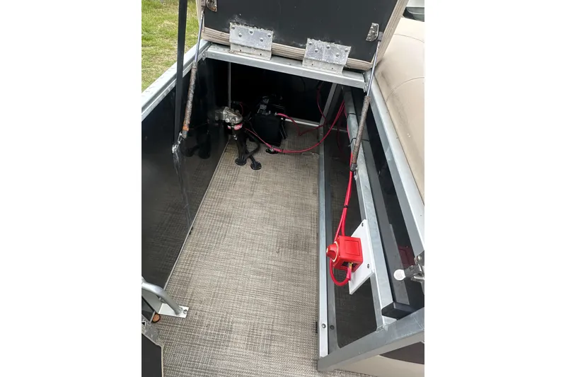 Slide: The Image of Storage compartment of a 2021 Bentley Pontoons 240 CRUISE with wiring and battery setup. - 19