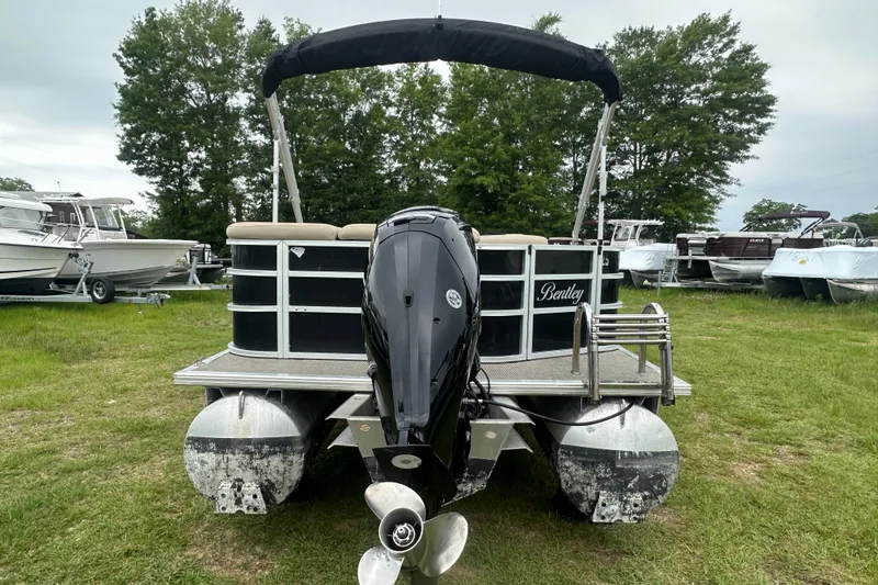 Slide: The Image of 2021 Bentley Pontoons 240 CRUISE on grass, surrounded by trees and other boats. - 4