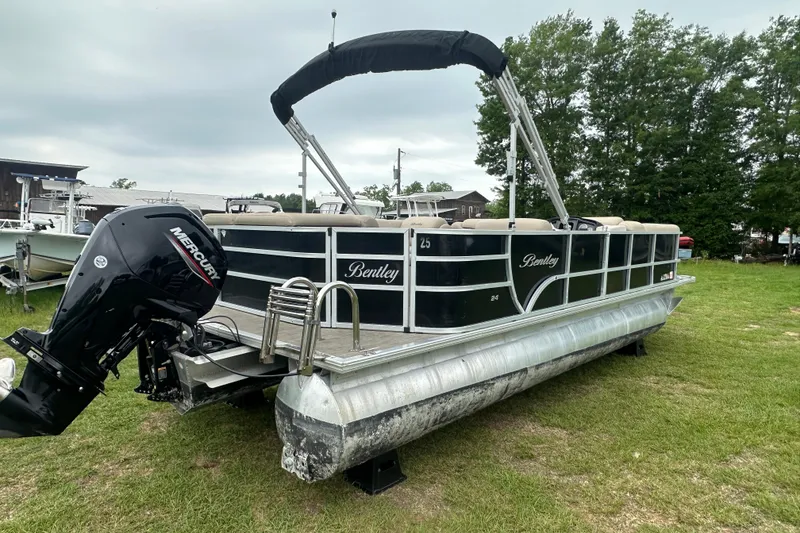 Slide: The Image of 2021 Bentley Pontoons 240 CRUISE on grass, featuring a Mercury outboard motor. - 5