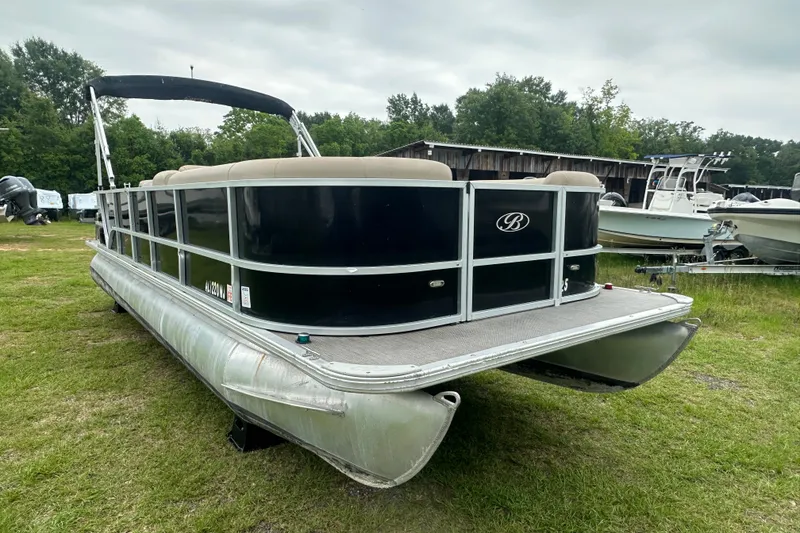 Slide: The Image of 2021 Bentley Pontoons 240 CRUISE pontoon boat on grassy area, featuring sleek black design. - 8