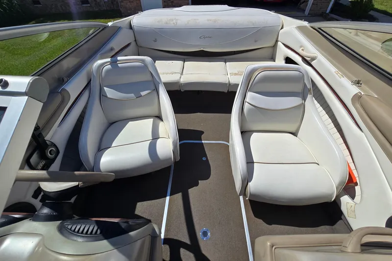 Slide: The Image of 1999 Bayliner 1850 Capri SS interior with white seating and steering wheel. - 11