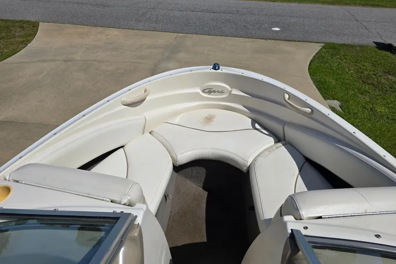 Slide: The Image of 1999 Bayliner 1850 Capri SS boat interior with white seating and open bow design. - 15