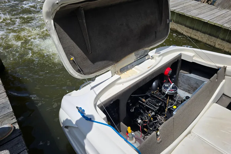Slide: The Image of 1999 Bayliner 1850 Capri SS boat engine compartment open at dockside. - 20