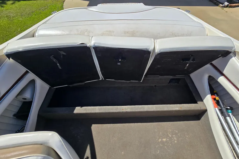 Slide: The Image of 1999 Bayliner 1850 Capri SS boat interior with open storage compartments. - 26