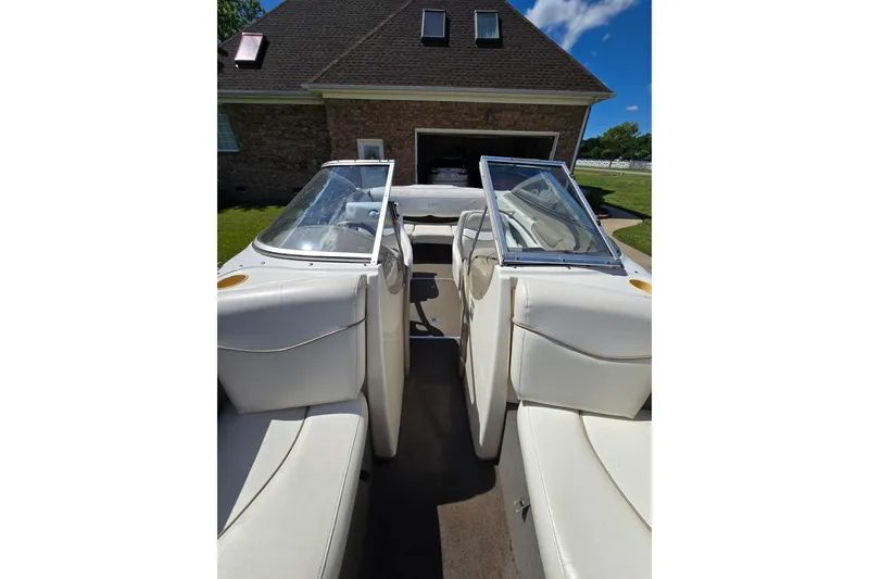 Slide: The Image of 1999 Bayliner 1850 Capri SS boat interior with white seating and open windshield. - 31