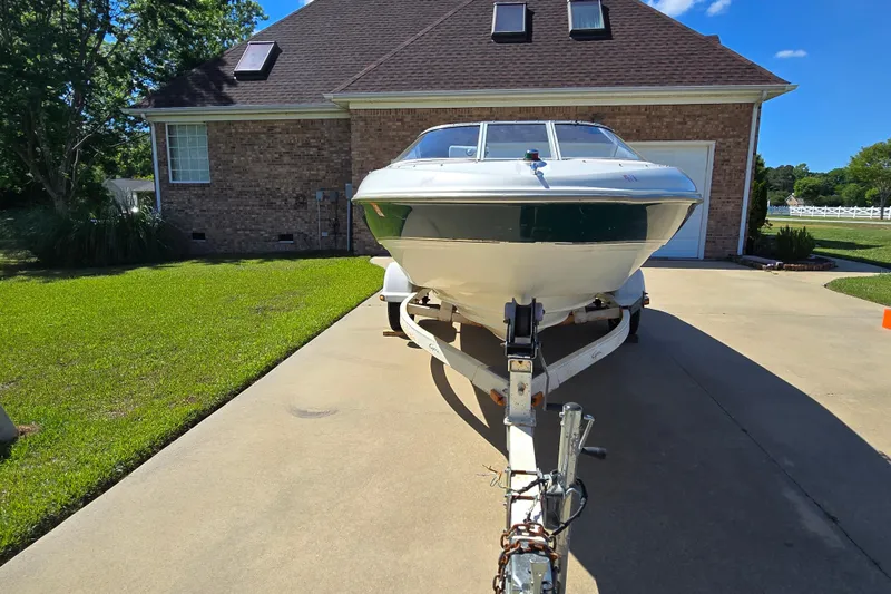 Slide: The Image of 1999 Bayliner 1850 Capri SS boat on trailer in driveway, sunny day. - 5