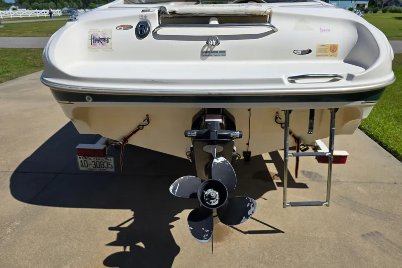 Slide: The Image of 1999 Bayliner 1850 Capri SS boat rear view with propeller and ladder. - 7