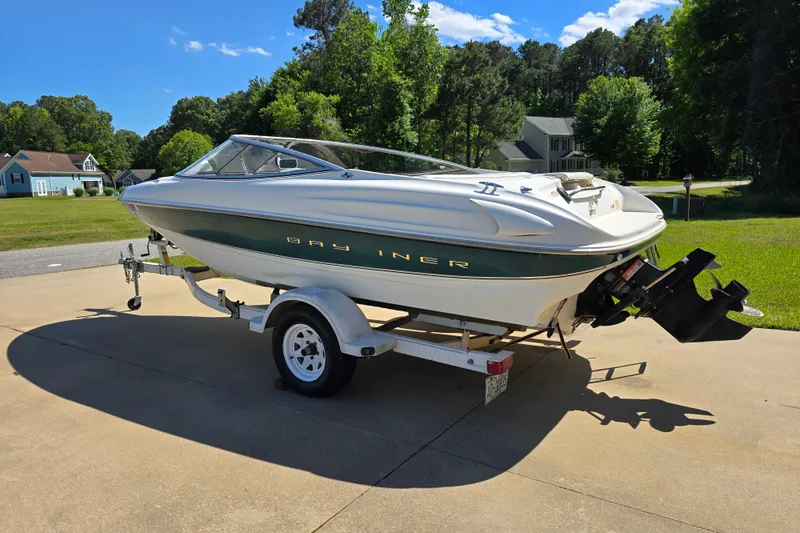 Slide: The Image of 1999 Bayliner 1850 Capri SS boat on trailer in sunny driveway. - 8