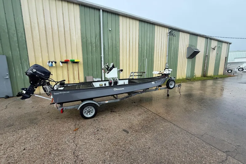 The Image of 2020 Gheenoe Lo Tide 25 boat on trailer, parked outside a warehouse. - 0