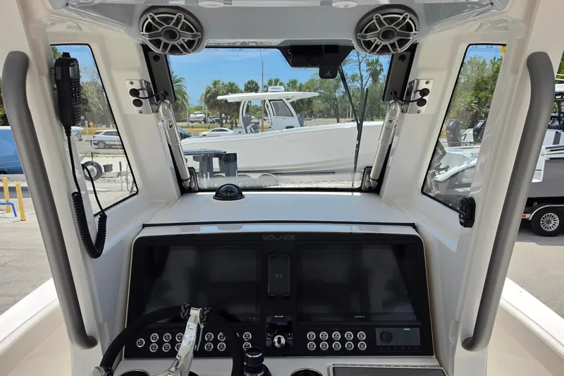 Slide: The Image of Interior view of 2026 Solace 28HCS boat cockpit with modern controls and steering wheel. - 11