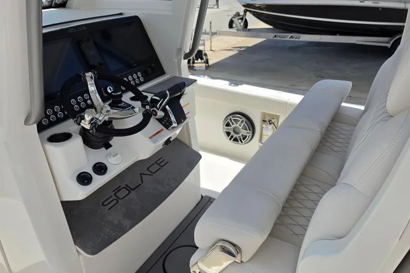 Slide: The Image of Helm of 2026 Solace 28HCS boat with modern controls and seating. - 13