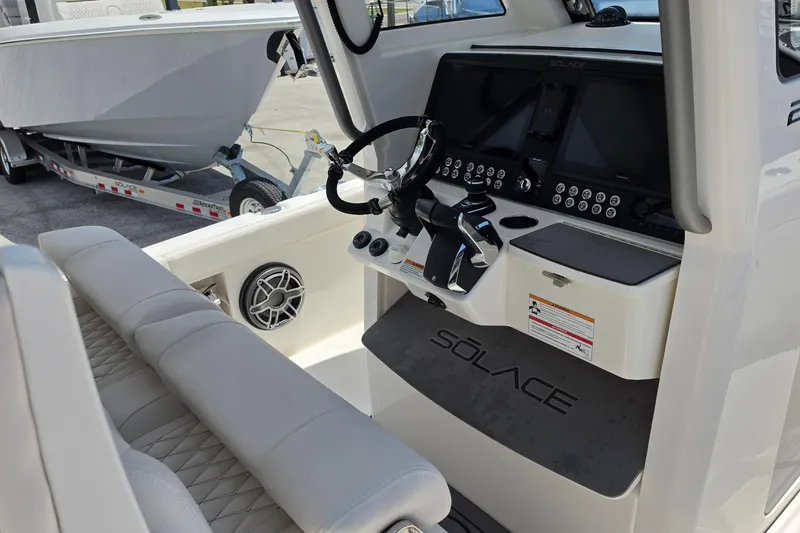 Slide: The Image of 2026 Solace 28HCS boat cockpit with advanced controls and comfortable seating. - 14