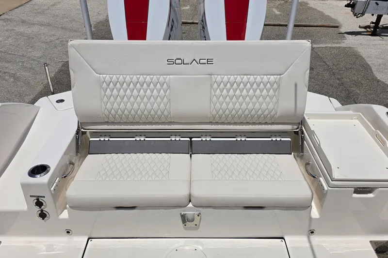 Slide: The Image of 2026 Solace 28HCS boat seating with diamond-stitched upholstery and integrated cup holders. - 15