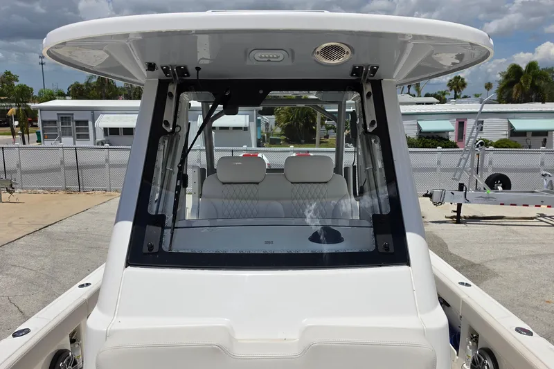 Slide: The Image of 2026 Solace 28HCS boat with sleek design and modern cockpit, parked outdoors. - 22