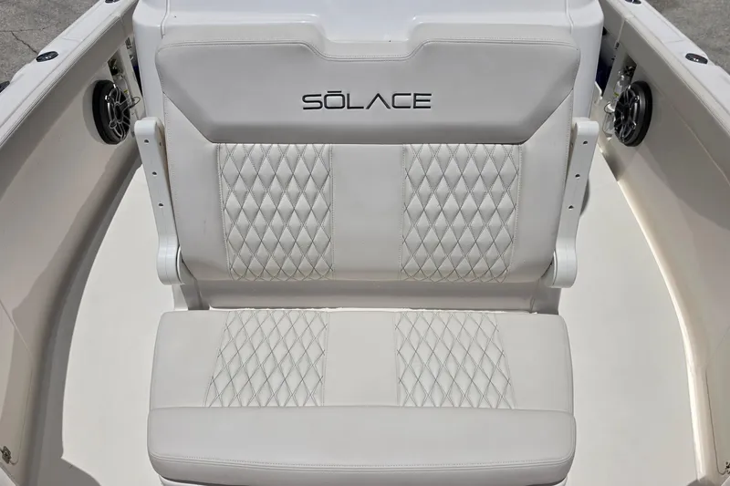Slide: The Image of 2026 Solace 28HCS boat seat with diamond-stitched white upholstery and logo. - 23