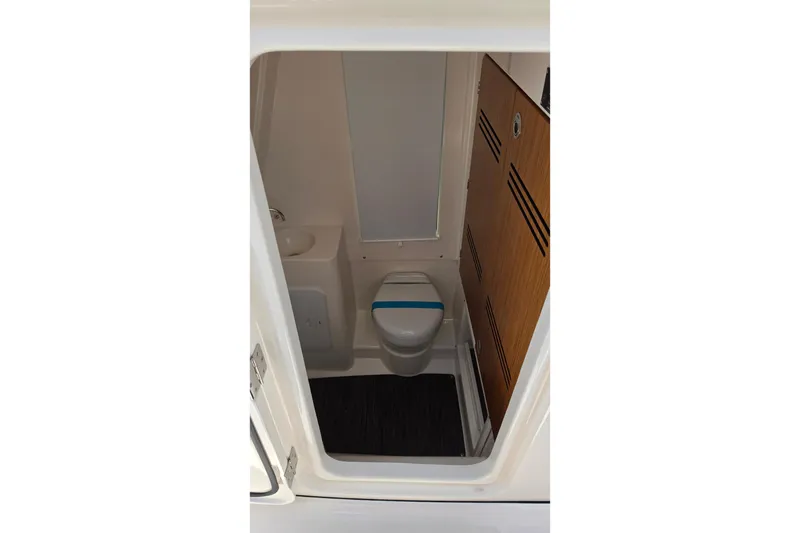 Slide: The Image of Compact bathroom in 2026 Solace 28HCS boat, featuring toilet and sink. - 24