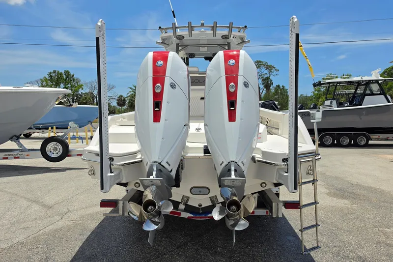 Slide: The Image of 2026 Solace 28HCS boat with dual outboard engines, displayed outdoors on a sunny day. - 3