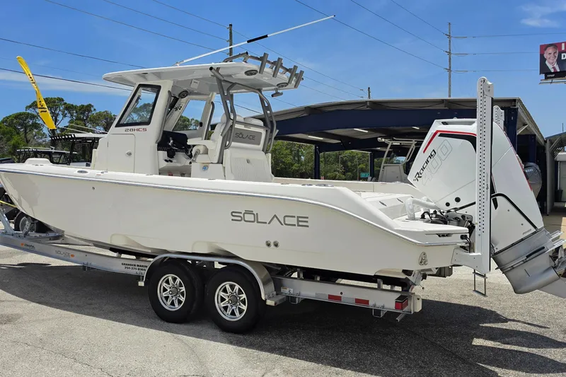 Slide: The Image of 2026 Solace 28HCS boat on trailer, featuring sleek design and powerful outboard engine. - 4