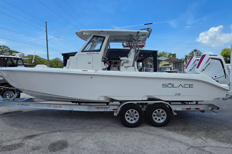 Slide: The Image of 2026 Solace 28HCS boat on trailer, side view, clear sky background. - 5