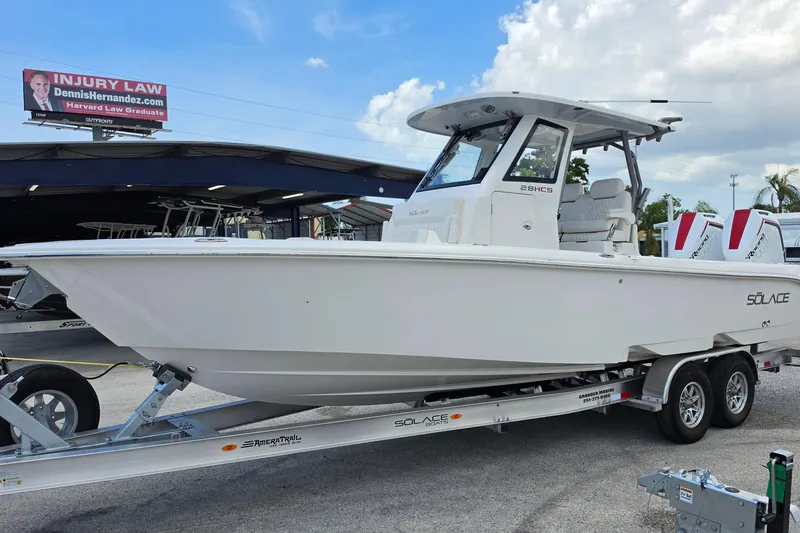 Slide: The Image of 2026 Solace 28HCS boat on trailer, displayed outdoors under a partly cloudy sky. - 6