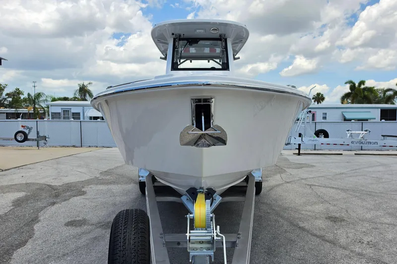 Slide: The Image of Front view of 2026 Solace 28HCS boat on trailer under cloudy sky. - 7