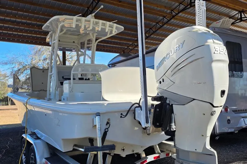 Slide: The Image of 2018 SeaVee 270Z boat with Mercury 350 engine, parked under a metal roof. - 12