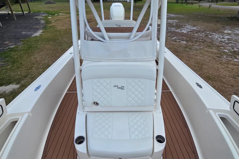 Slide: The Image of 2018 SeaVee 270Z boat interior with white seating and brown deck. - 4