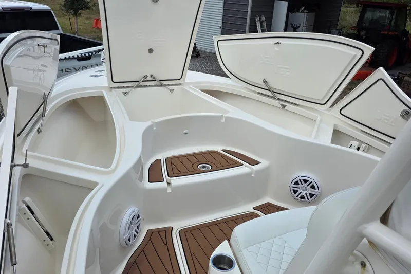 Slide: The Image of 2018 SeaVee 270Z boat interior with open storage compartments and teak flooring. - 5