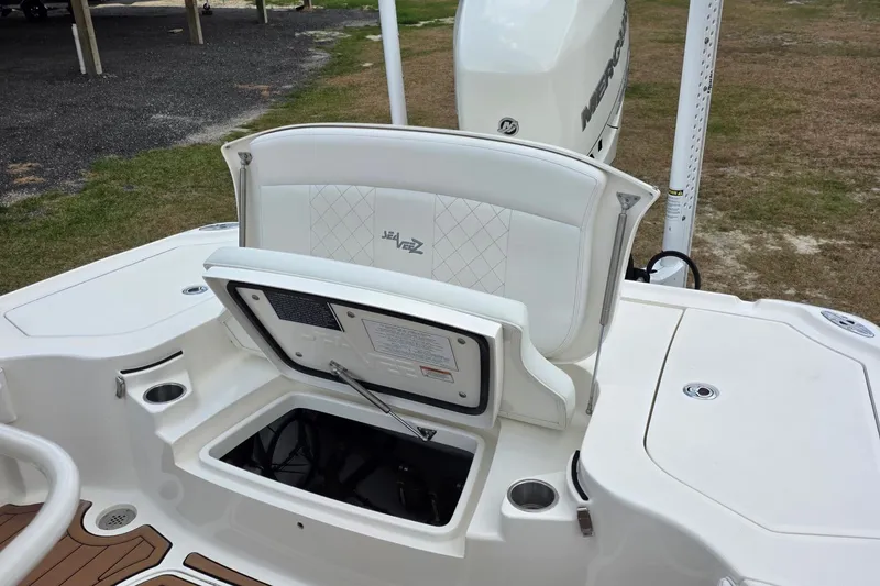 Slide: The Image of 2018 SeaVee 270Z boat with open storage compartment and white seating. - 6