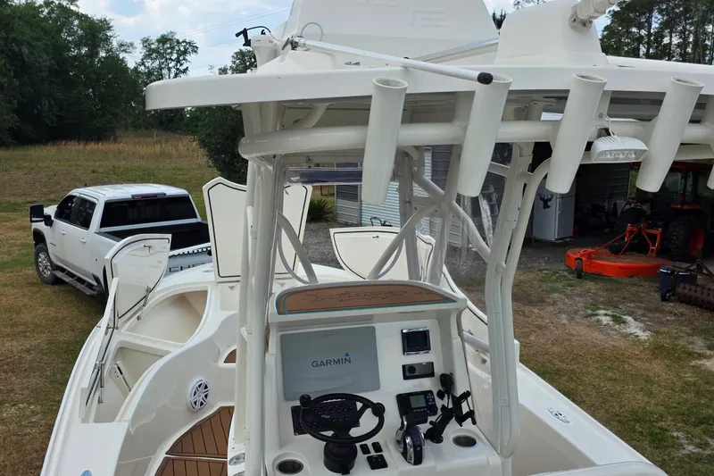 Slide: The Image of 2018 SeaVee 270Z boat with Garmin electronics, parked near a white truck and tractor. - 8