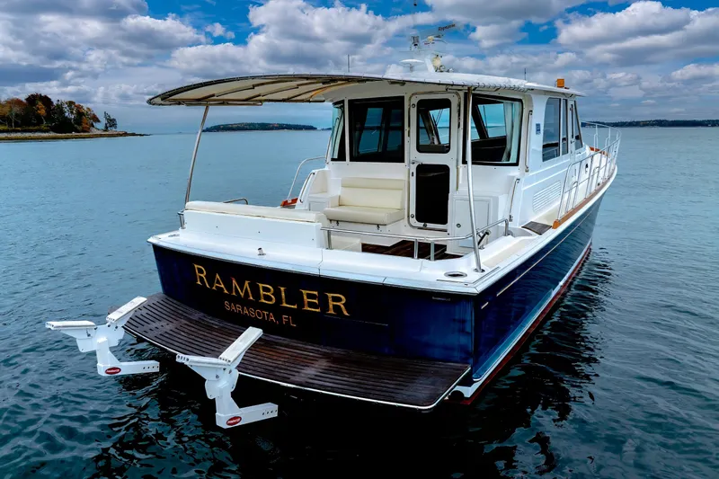 Slide: The Image of 2014 Grand Banks 46 Eastbay SX yacht on calm water, featuring "Rambler" from Sarasota, FL. - 17