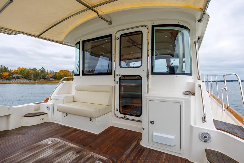 Slide: The Image of 2014 Grand Banks 46 Eastbay SX yacht with teak deck and cushioned seating. - 18
