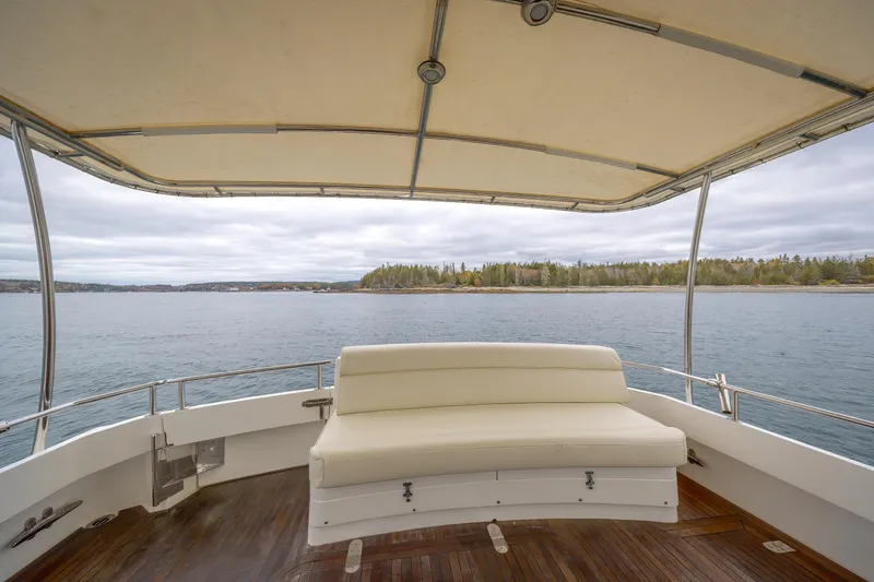 Slide: The Image of 2014 Grand Banks 46 Eastbay SX yacht with covered deck and scenic water view. - 22