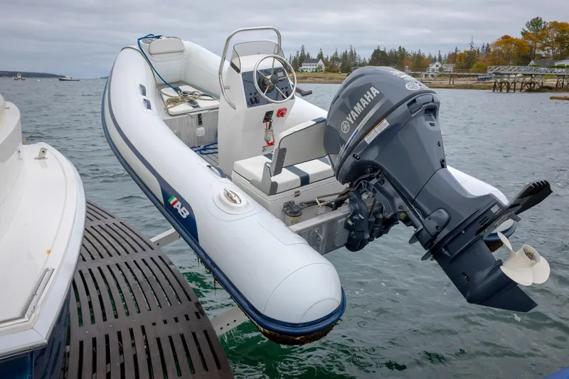 Slide: The Image of Inflatable boat with Yamaha motor on Grand Banks 46 Eastbay SX, 2014 model, docked by the water. - 25