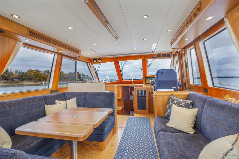 Slide: The Image of Luxurious interior of 2014 Grand Banks 46 Eastbay SX yacht with plush seating and panoramic windows. - 26