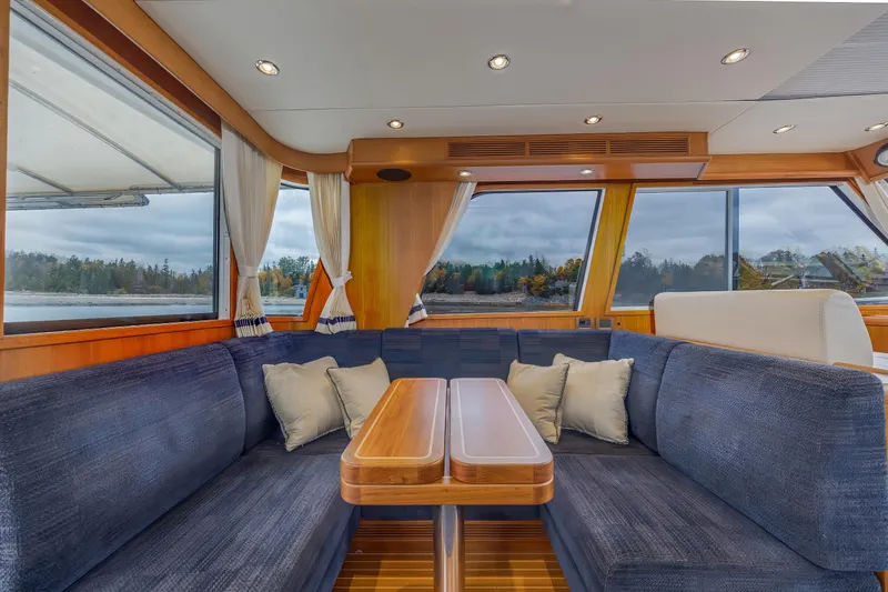 Slide: The Image of Luxurious interior of 2014 Grand Banks 46 Eastbay SX yacht with plush seating and scenic windows. - 28