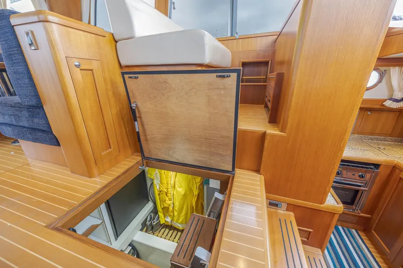 Slide: The Image of Interior of 2014 Grand Banks 46 Eastbay SX yacht with wooden flooring and storage access. - 36