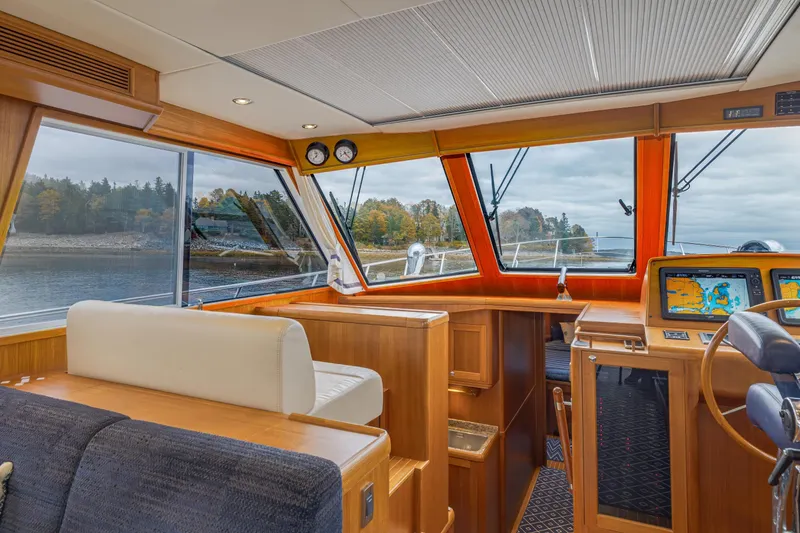 Slide: The Image of Luxurious 2014 Grand Banks 46 Eastbay SX yacht interior with navigation equipment and scenic water view. - 37