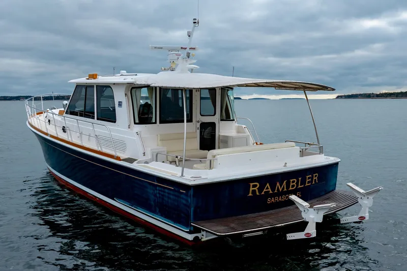 Slide: The Image of 2014 Grand Banks 46 Eastbay SX yacht on calm waters, overcast sky. - 4