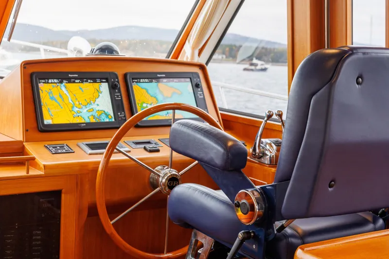 Slide: The Image of Helm of 2014 Grand Banks 46 Eastbay SX with navigation screens and leather chair. - 40