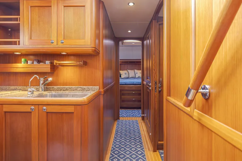 Slide: The Image of Luxurious wooden interior of 2014 Grand Banks 46 Eastbay SX yacht, featuring a cozy cabin. - 44