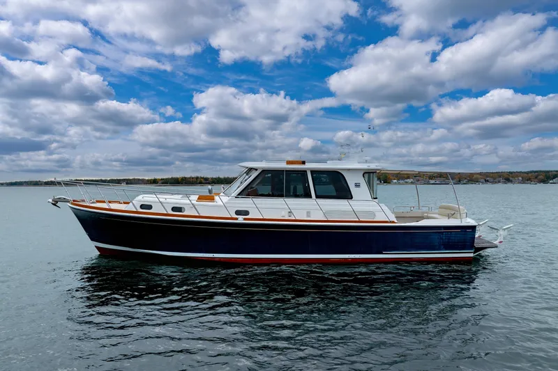Slide: The Image of 2014 Grand Banks 46 Eastbay SX yacht on calm water under cloudy sky. - 5
