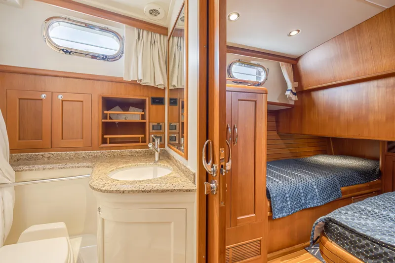 Slide: The Image of Luxurious 2014 Grand Banks 46 Eastbay SX yacht interior with wood finish and cozy cabin. - 51