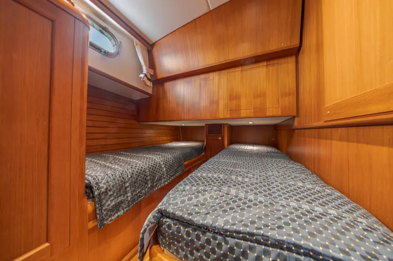 Slide: The Image of Luxurious wooden cabin interior with twin beds on a 2014 Grand Banks 46 Eastbay SX yacht. - 53