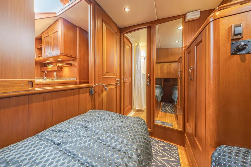 Slide: The Image of Luxurious 2014 Grand Banks 46 Eastbay SX yacht interior with wood finish and cozy bedding. - 54