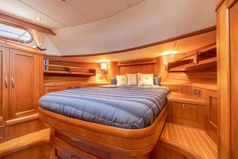Slide: The Image of Luxurious 2014 Grand Banks 46 Eastbay SX yacht cabin with elegant wood finish and cozy bedding. - 56