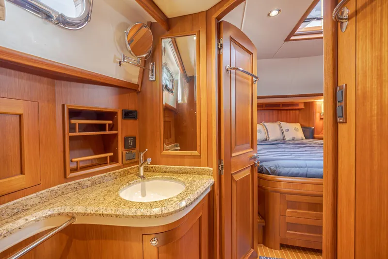 Slide: The Image of Luxurious 2014 Grand Banks 46 Eastbay SX yacht interior with elegant wood finish and cozy bedroom. - 62