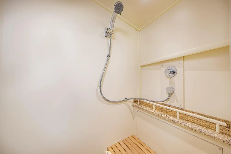 Slide: The Image of Shower area in 2014 Grand Banks 46 Eastbay SX yacht, featuring modern fixtures and wooden bench. - 64